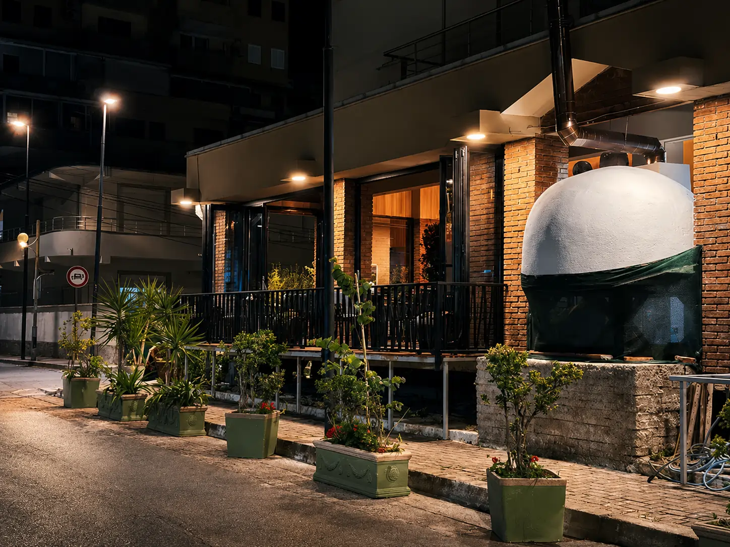 Antika pizzeria at night — brick façade and wood-fired oven